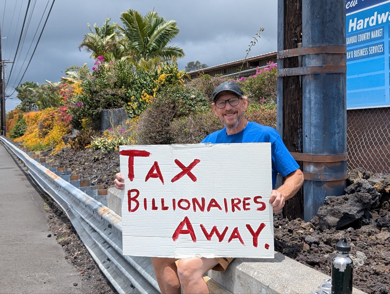 Greg holding Tax Billionaires Away sign